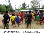 Small photo of Kiriwina Island, Trobriand Islands, Papua New Guinea, October 2, 2019. Locals and Visitors watching a traditional Performance of Song and Dance