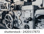 Small photo of View of old lathe for metal processing in turning shop. Close-up photo of outdated equipment.