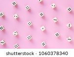 Gaming dice pattern on pink...