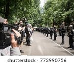 Small photo of Portland, Oregon, USA - June 4th, 2017: A documentarian records the line of riot police