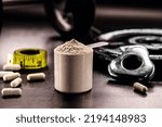 Small photo of Measuring Spoon with Creatine or Whey, Food Supplement, Casein Cocktail, Muscle Mass Vitamin, Plated, Bodybuilding Concept