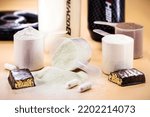 Small photo of spoons with Creatine, whey and casein, amino acid pills, food supplements and protein bar for physical exercises, gym in the background, muscle mass gain