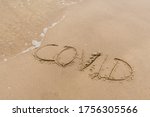 Covid free, stop Covid, safe beach and holiday, word written on the sand, vaccine