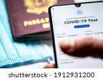 Small photo of Rome, Italy, - January 17 2021: Covid test requirements and procedures. Covid-19 immunity health pass app. Vaccine certificate or passport app displayed an a smartphone with passport and facial mask