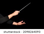Small photo of Orchestra woman conductor music conducting. Hands of conductor with baton on black background