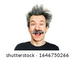 Small photo of Portrait of jocular aging man with grey long hair smiling with open mouth, sticking his tongue out in Einstein manner. Isolated on background.
