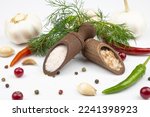 Salt in wooden spoons, spices, dill, hot pepper and garlic isolated on a white background.