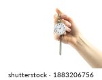 Small photo of Old pocket watch in a woman's hand on a white background. The concept of a bygone time.