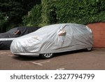 Vehicle under protective cover in parking space