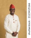 Small photo of Yoruba Culturally Dressed Business Man with Hands Clasped Close-up with Big Smile