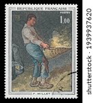 Small photo of Ankara, Turkey - 20 March 2021: A French postage stamp shows picture Winnower by French painter Jean-Francois Millet. Circa 1971. Canceled by seal...