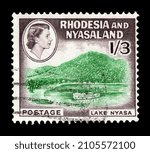 Small photo of Ankara, Turkey - 01,13,2022: A Federation of Rhodesia and Nyasaland postage stamp shows image portrait of Queen Elizabeth II against beautiful view of Nyasa Lake. Circa 1959