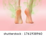 Small photo of Women's feet, standing on tiptoes, showing the heel, which emanates an unpleasant smell of greenish color. Pink background. Copy space. The concept of skin diseases, foot fungus