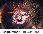 Small photo of The fortune teller holds a watch on a chain in her hands and conjures over it. A luminous zodiac circle is depicted around the clock. The concept of divination, astrology and predicting the future.