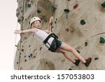 A Teen Girl Climbing On A Rock...