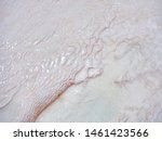 Small photo of Undulatory texture of white calcite stalactites covering a cascade of terraced baths in Pamukkale, Turkey. Included in the UNESCO list of natural heritage. Unusual background