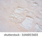 Small photo of Undulatory texture of white calcite stalactites covering a cascade of terraced baths in Pamukkale, Turkey. Included in the UNESCO list of natural heritage.