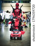 Small photo of Miami, Florida / USA - June 2015 : Men cosplaying / dressing up as Deadpool at the Comicon convention