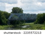 View of the steel railway bridge over a small river