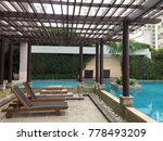 Small photo of Lounge Chair At Swimming Pool Under Trelliswork