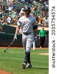 Small photo of Oakland, California - August 28, 2021: New York Yankees' Giancarlo Stanton #27 walks back to the dugout after striking out against the Oakland Athletics at RingCentral Coliseum.