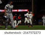 Small photo of San Francisco - June 8, 2022: Colorado Rockies Elias Diaz walks off the field as San Francisco Giants Evan Longoria and Joc Pederson celebrate a 10th inning walk off at Oracle Park.