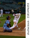 Small photo of Oakland, California - July 5, 2022: Oakland Athletics shortstop Elvis Andrus bats against the Toronto Blue Jays at the Oakland Coliseum.
