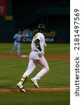 Small photo of Oakland, California - July 5, 2022: Oakland Athletics shortstop Elvis Andrus runs to first base during a game against the Toronto Blue Jays at the Oakland Coliseum.
