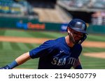 Small photo of Oakland, California - August 21, 2022: Seattle Mariners outfield Mitch Haniger jogs to the dugout after hitting a home run against the Oakland Athletics at the Oakland Coliseum.