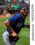 Small photo of Oakland, California - August 21, 2022: Seattle Mariners shortstop J.P. Crawford runs on the field during a game against against the Oakland Athletics at the Oakland Coliseum.