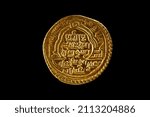 Ancient golden islamic coins isolated on black, closeup. ilkhanid empire coin