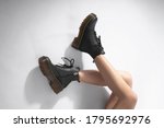  woman in black leather shoes from the new collection on a white background girl's legs in fashionable eco-leather shoes fall-winter 2022.close-up mockup                           