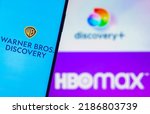 Small photo of August 5, 2022, Brazil. In this photo illustration, the Warner Bros. Discovery logo is displayed on a smartphone screen and in the background, the HBO Max and Discovery Plus logos