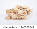Wooden clothes pegs isolated on a white background.
