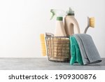 Brushes, sponges, rubber gloves and natural cleaning products in the basket.  Eco-friendly cleaning products