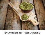 Mung beans in a spoon on a wooden table