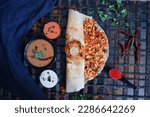 Small photo of Masala Dosa - This is a popular South Indian dosa variety made with a potato filling known as masala. The dosa is made by spreading a thin layer of fermented rice and lentil batter on a hot griddle, a