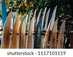 Small photo of Set of different color surf boards in a stack by ocean.WELIGAMA, SRI LANKA. Surf boards on sandy Weligama beach in Sri Lanka. surf is available all year around for beginner and advanced