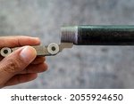 Small photo of Measurement the pipe threads with thread pitch gauge or screw pitch gauge.