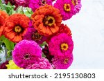 Bouquet of pink and red gerbera daisy flowers on white table background. Top view, copy space.  Colorful gerber autumn flowers. 
