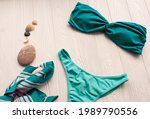 Women split multicolor blue swimsuit bikini. Summer background mockup template. pattern top view above swimwear white wooden background. accessories clothes beach. Women summer design vacation