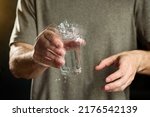 A man holds a glass of water...