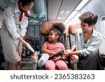 Small photo of Friendly air hostess take care kid passenger on airplane, flight attendant teach curly hair African girl to use seat belt during sit in aircraft seat, child traveling by plane, airline transportation