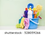 House cleaning product on wood table with green background