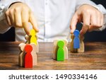 Small photo of Groups of multicolored wooden people and businessman. The concept of market segmentation. Target audience, customer care. Market group of buyers. Customer relationship management. Selective focus