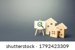 Small photo of Residential buildings and easel with magnifying glass and green check mark. Compliance of housing with the necessary criteria and quality standards. Search for real estate to buy. Realtor services.