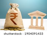 Indian rupee money bag and bank  government building. Budgeting, national financial system. Resource allocation. Support businesses in crisis. Lending loans, deposits. Monetary policy.