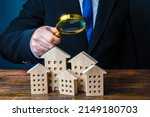 Small photo of A man inspects houses. Search for real estate for sale offers. Property valuation. Audit and revision of the city. Checking the effectiveness of the work of authorities and city services.