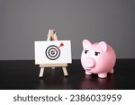 Small photo of Pig piggy bank and goal achievement. Achieving the aim and completing the mission. Advertising, marketing and targeting. Clear and specific goals. Accurate decisions. Archery. Striving for excellence