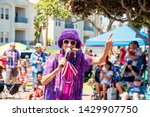 Small photo of Huntington Beach, CA / USA - July 4, 2018: Aunt Gertie smoking a cigar in the Huntington Beach 4th of July Parade